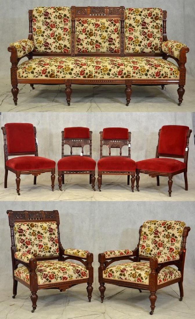 (7) pc Carved walnut Eastlake Victorian parlor set: (7) pc carved walnut Eastlake Victorian parlor set, triple back sofa with two armchairs, 4 side chairs, some with red velvet upholstery and some with floral needlepoint upholstery, sofa 67"w x 37"h