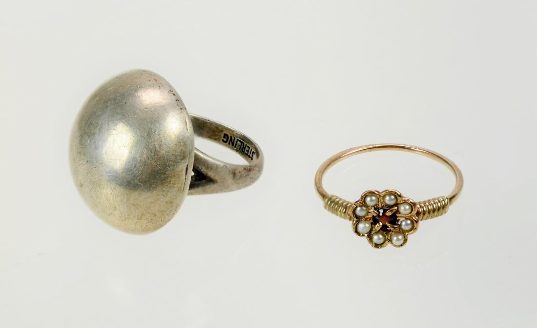 10K Gold Ring and Sterling Ring: (1) 10K Garnet and Pearl Ring Size 5-1/2 (.7 dwt), (1) Sterling Ring Size 4-1/2 (.16 TO)