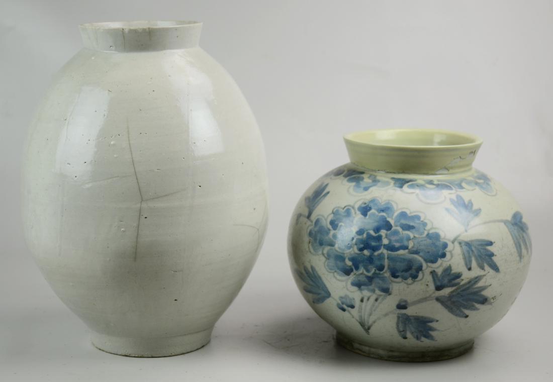 Two pieces of Asian pottery: Two pieces of Asian pottery, possibly Korean, c/o plain gray vase, hairline cracks around lip and spider on side, 14â€ h x 10â€ dia, and blue floral vase, repairs to neck under chipping overpain