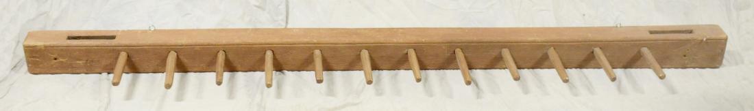 Large brown/red painted hanging rack: Large brown/red painted hanging rack, hand hewn pegs, 84"w