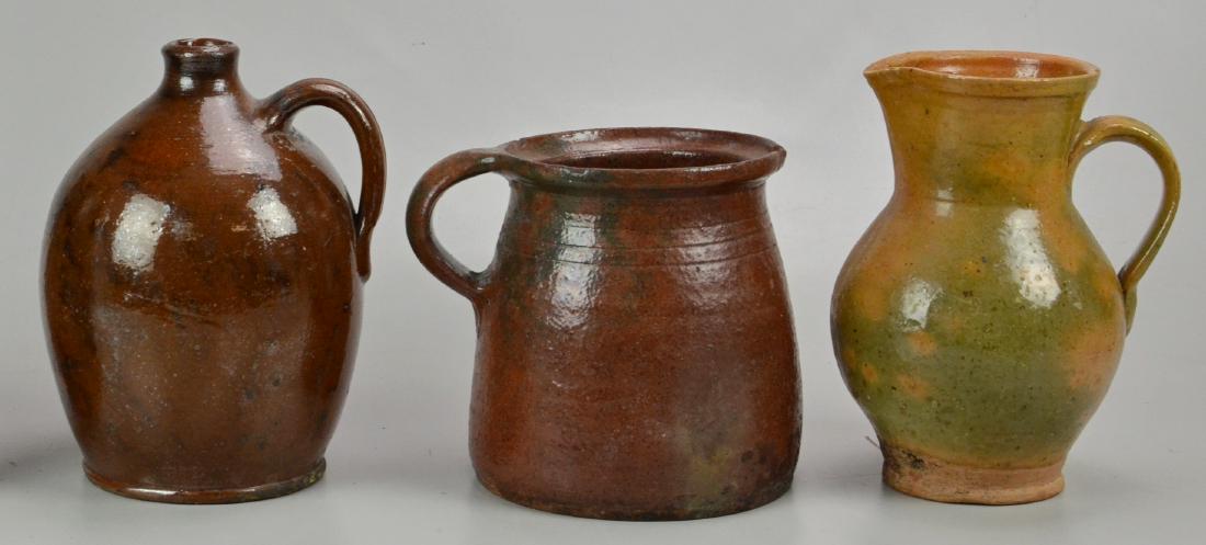 (3) Pieces of Redware: (3) Pieces of redware Including a jug and (2) pitchers (tallest 7" dia x 9" h), chips on rims and bases