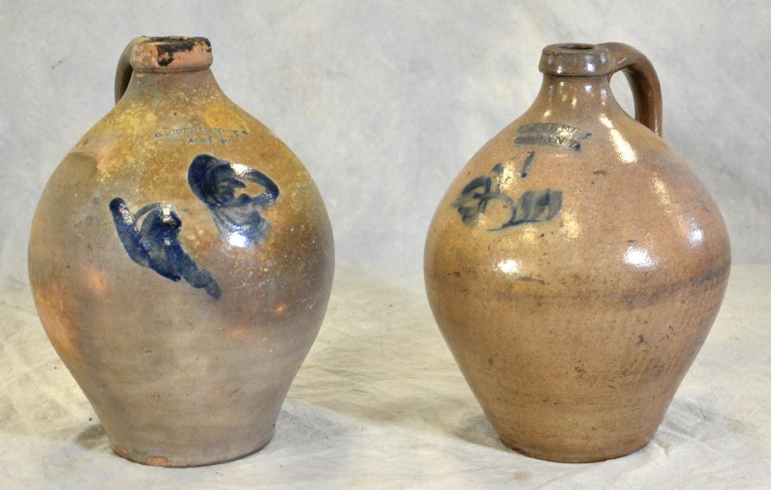 (2) Stoneware Jugs: Orcutt and Smith Stoneware Jug with Blue Decoration 12" h x 9" dia, chips to the base and black residue on the rim, 1 Gallon M. Tyler Stoneware Jug with Blue Decoration, 11-1/2" h x 9" dia, some chips