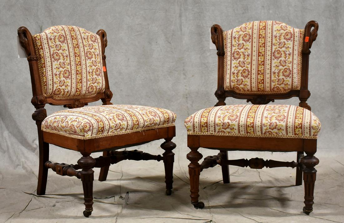 Pair carved walnut Victorian slipper chairs: Pair carved walnut Victorian slipper chairs, with swan heads at tops of posts, clean striped floral and tan upholstery, 32-1/2"h