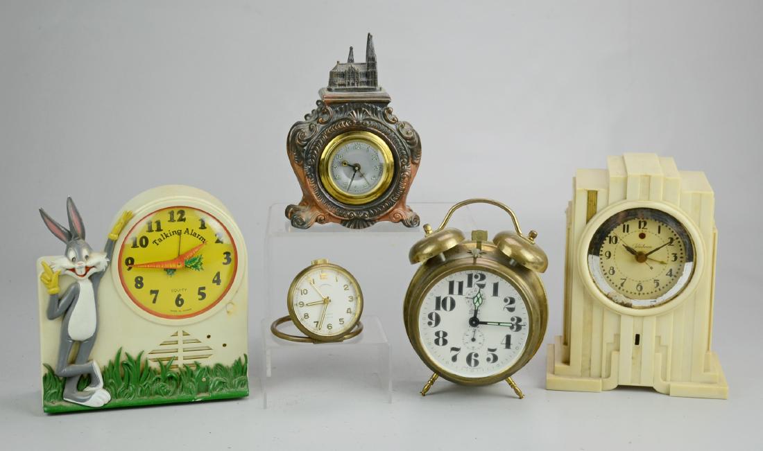 (5) Clocks: (5) Clocks Including Bailey Banks and Biddle Desk Clock (Runs when wound, no warranty intended), Spelter Clock Adorned by Cathedral, Telechron Art Deco Skyscraper Clock (6" l x 3.75" w x 7-1/2" h), (M