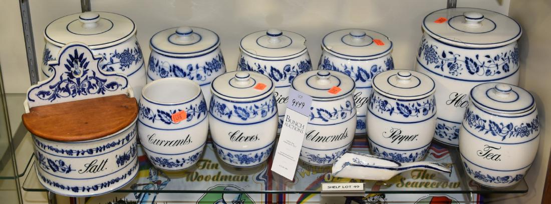 Shelf #49 - 10-Pc German Porcelain Canister Set: Shelf #49 - 10-Pc porcelain canister set with salt box & a scoop, Blue Onion pattern, marked "Geschutzt Depose", one missing lid, some chips