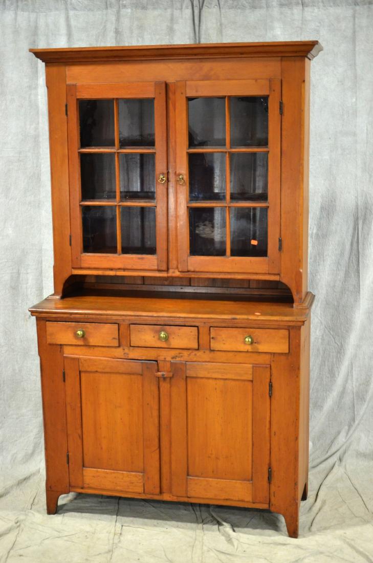 Pine 12 pane 2 pc Dutch cupboard, c 1820-1840: Pine 12 pane 2 pc Dutch cupboard, American, circa 1820-1840, molded cornice over two glazed 6 pane doors, shelves to interior, lower case with three dovetailed side by side drawers having brass pulls 