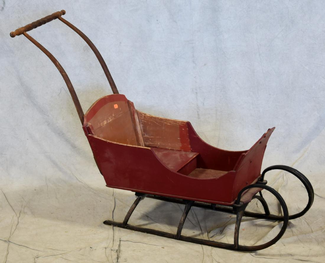 Red painted child's sled: Red painted child's sled, with iron runners, 33" h at handle, 46" l at widest point