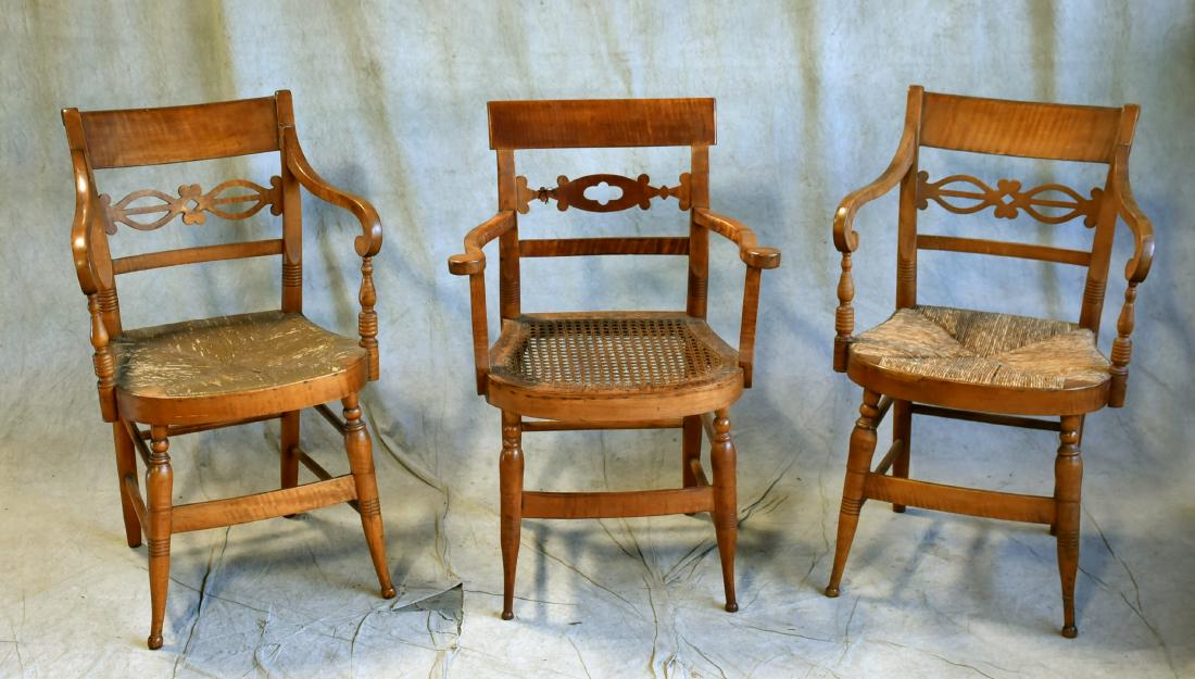 (3) Figured maple armchairs: (3) Figured maple armchairs, figural cutout back braces, one caned and two with rush seats (wear to rushes)