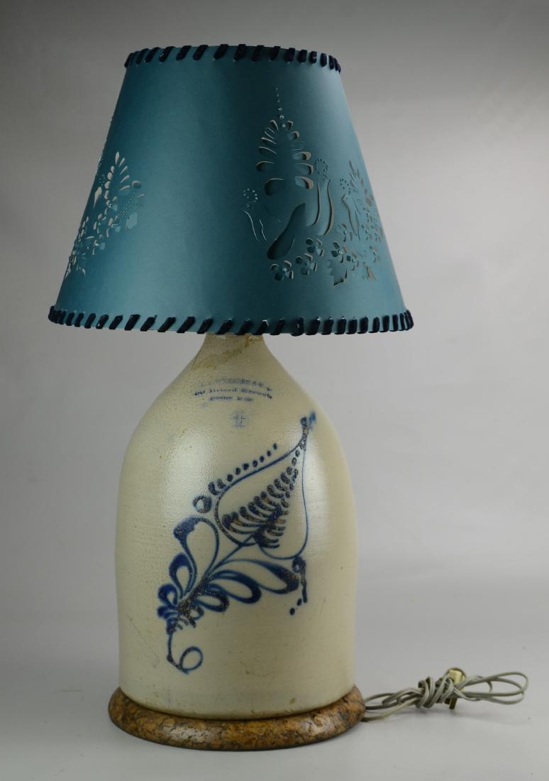 AB Wheeler Stoneware Jug Lamp: 4-Gallon blue decorated stoneware jug, "AB Wheeler & Co / 69 Broad Street / Boston Mass", mounted as a table lamp, pierced paper shade with velvet ribbon lacing, jug 17" h, repair to neck