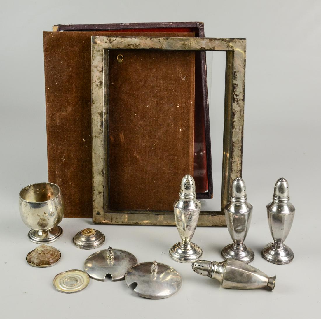 Lot of Sterling Silver: Lot of sterling silver, including (2) picture frames, (2) condiment jar lids, (4) shakers, footed cup, approx 14.5 TO, Frames measure 10-1/4"h x 8-1/4"w, second 10"h x 7-1/2"w