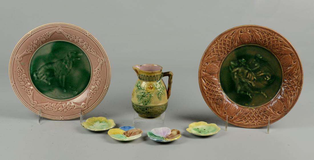 (7) Pcs Phoenixville Etruscan Majolica: (7) Pcs Griffin Smith & Hill Phoenixville PA pottery Etruscan Majolica, c/o cream pitcher (chips to rim), dog plate, classical figures plate, 2 pansy cup plates, 2 leaf cup plates, largest 9" dia