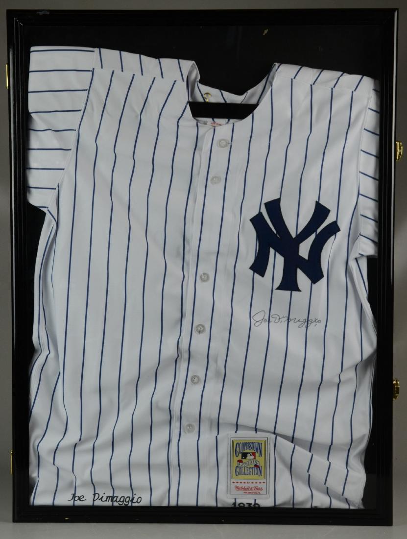 Joe DiMaggio Jersey: Joe DiMaggio Cooperstown Authentic Collection, full jersey, Mitchell & Ness, embroidered Yankee logo 1939 & signature on jersey in the likeness of "Joe DiMaggio" in script, size 50, in locked display 