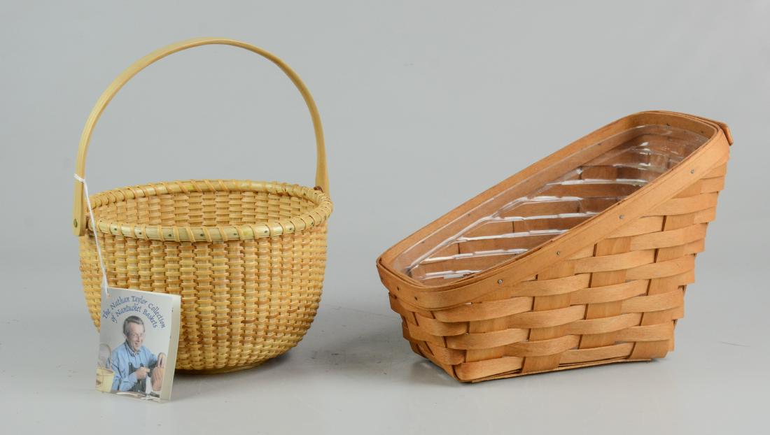 (2) Baskets: (2) Baskets, c/o Longaberger slanted wine basket with plastic liner, signed "LAR 1993", 9-1/2" x 6-1/2" x 7" h, and Nathan Taylor Basketville Nantucket basket with swing handle, 7-3/4" dia x 4-3/4" h 