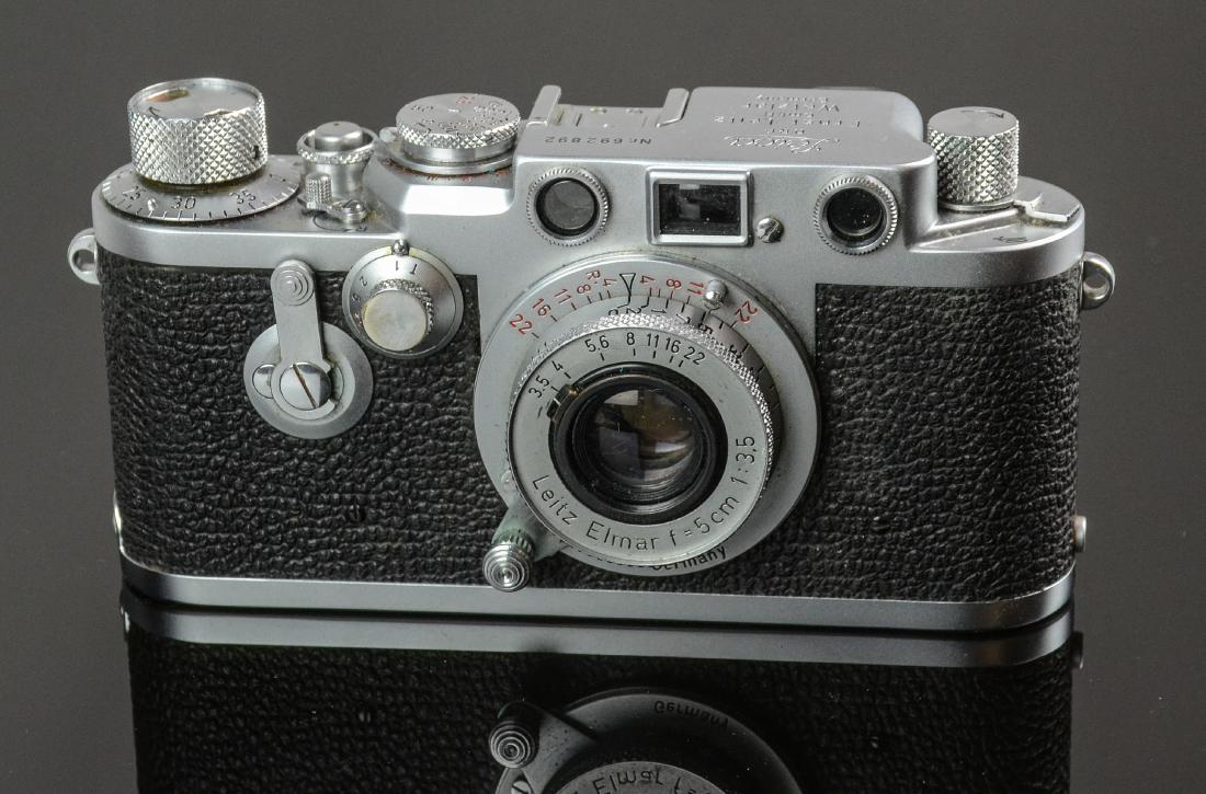Leica IIIf w. Collapsible Elmar F=5cm 1:3.5: Leica IIIf 35mm rangefinder camera with collapsible f=5cm 1:3.5 Elmar lens. Red contact numbers and self timer model, shutter operates nicely though sticky at very low speeds. Curtain appears in good 