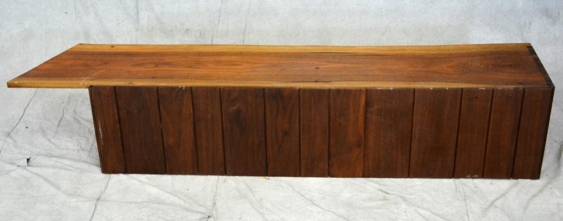 Manner of George Nakashima walnut hanging cabinet: Manner of George Nakashima walnut hanging cabinet, with sliding doors, free form top, 71"w x 13"d x 14-1/2"h