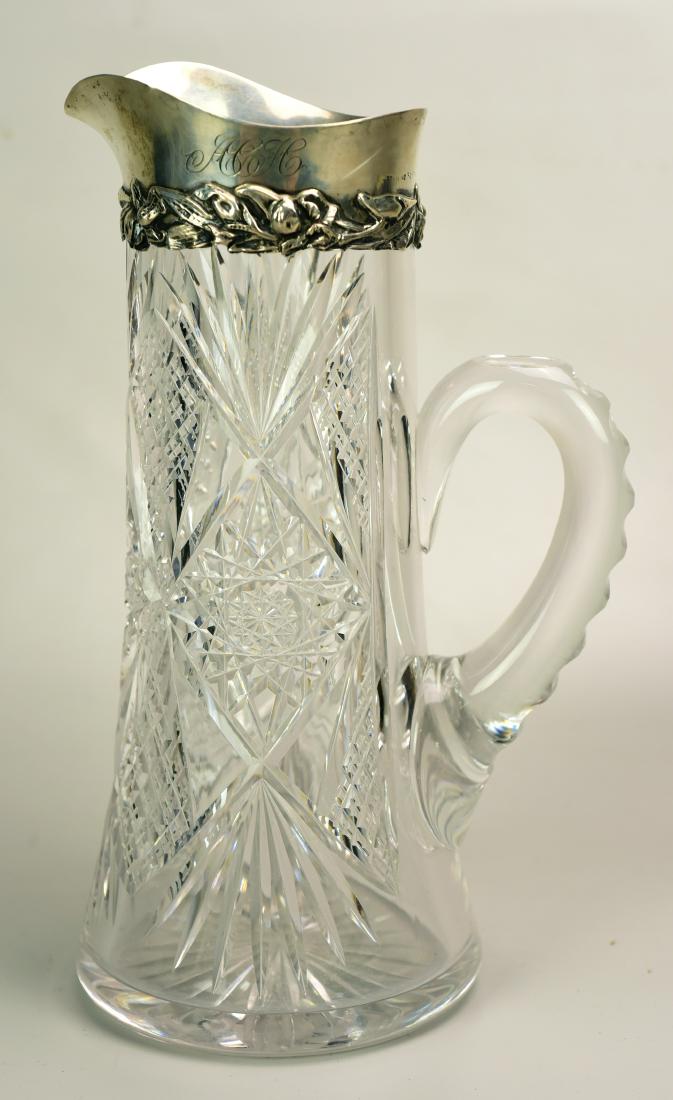 Sterling Rim Pitcher: Cut glass pitcher with sterling silver rim, hobstar & fan cut, floral decoration on silver, 3 initial monogram, applied handle, 9-7/8" h