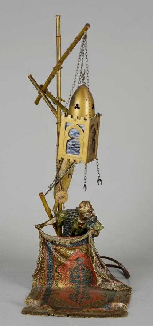 Franz Bergman bronze Arab rug seller lamp: Franz Bergman bronze Arab rug seller lamp, Austrian, impressed to underside with Bergman amphora 'B' mark, stamped "Geschnitzt" and "5917", depicting an Arab carpet seller spreading a rug beneath a gl
