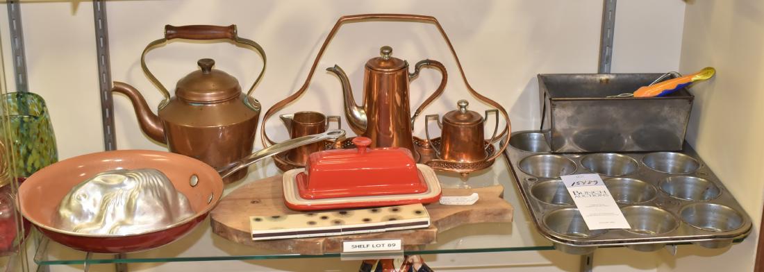 Shelf #89 - Kitchen Items: Shelf #89 - Kitchen items, including Le Creuset covered butter dish, fish shaped cutting board, rabbit mold, copper tea set with carrier, copper tea kettle, Bulbhead frying pan, muffin tin, tin loaf p