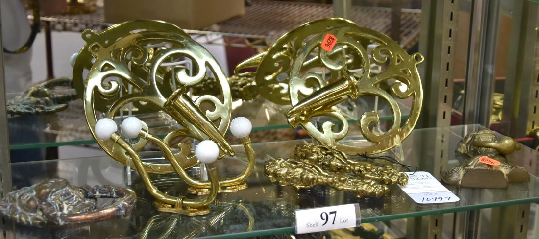 Shelf #97 - Brass Items: Shelf #97 - Brass, including (2) ornate figural nutcrackers with cherubs, foo dog door knocker, lion door knocker, pr coat hooks with porcelain balls, pr Virginia Metalcrafters single candle wall scon