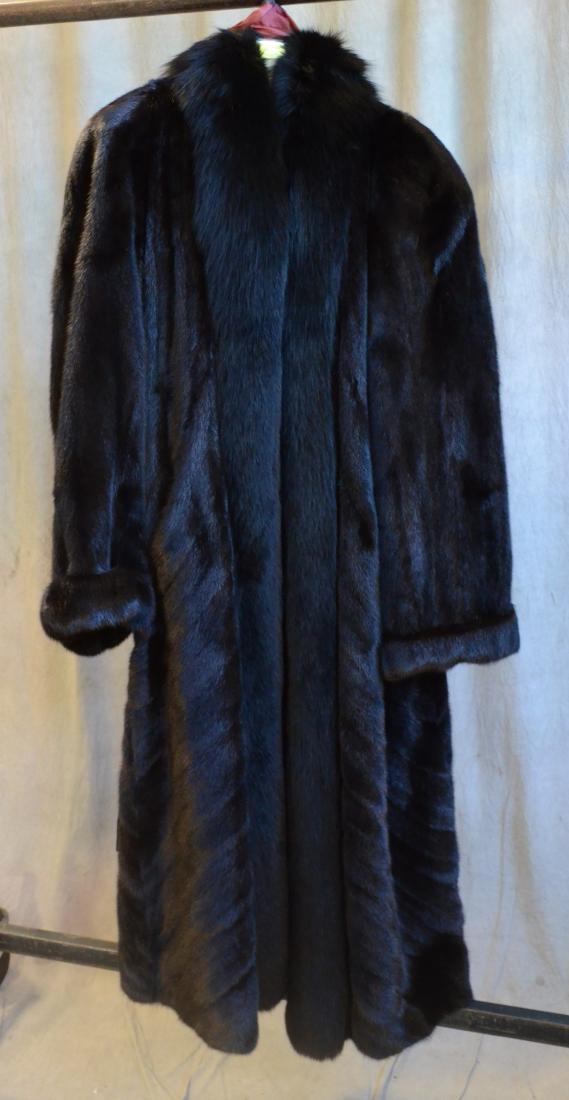 Full Length Reversible Black Mink with Fox Trim: Full length let-out Finnish female ranch mink directional reversible coat with black fox tuxedo front and collar. Straight mink sleeves with upturned cuffs. 50" length 63" sweep, pristine. Includes fo