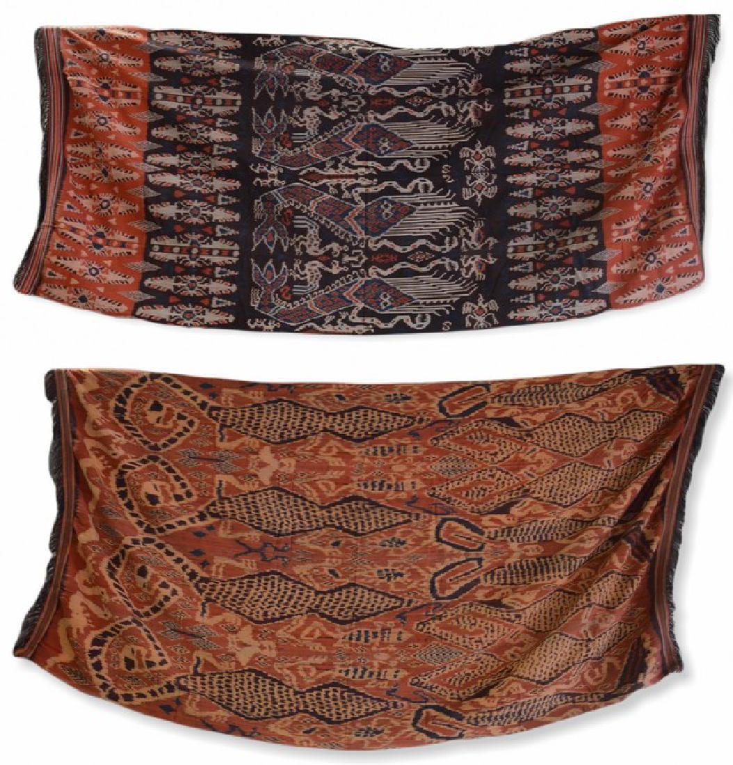 (2) Finely Woven Indonesian Textiles: Finely woven Indonesian textile grouping to include purple, navy and brick washed panel with animalia trimmed in fringe, 38" x 93", and rust, orange and purple washed panel with mirrored and repeated 