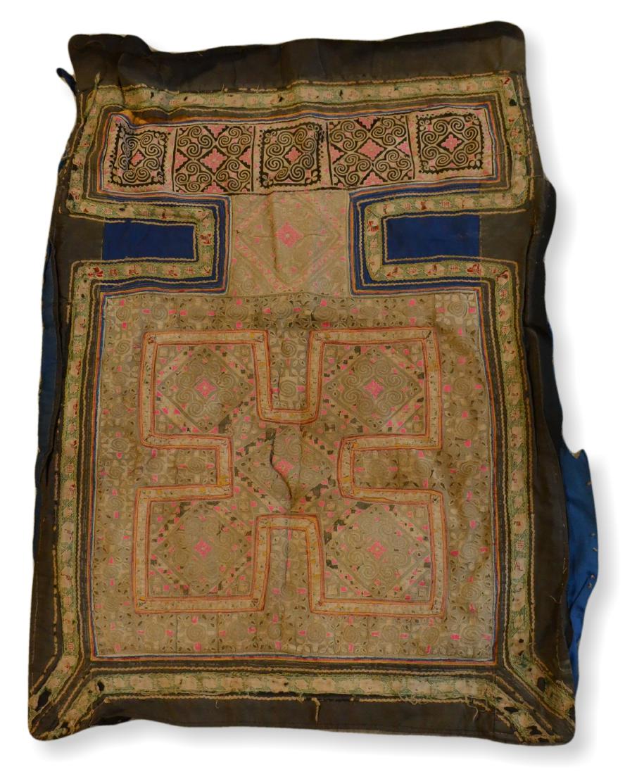 Tribal Embroidery From The Mien/Yao Tribe: A rare indigo-lined apron of red, yellow, green and black stitching on a cream ground, with two indigo squares and a colorfully embroidered waist band. A tribal embroidery from the Mien a.k.a. Yao, tr