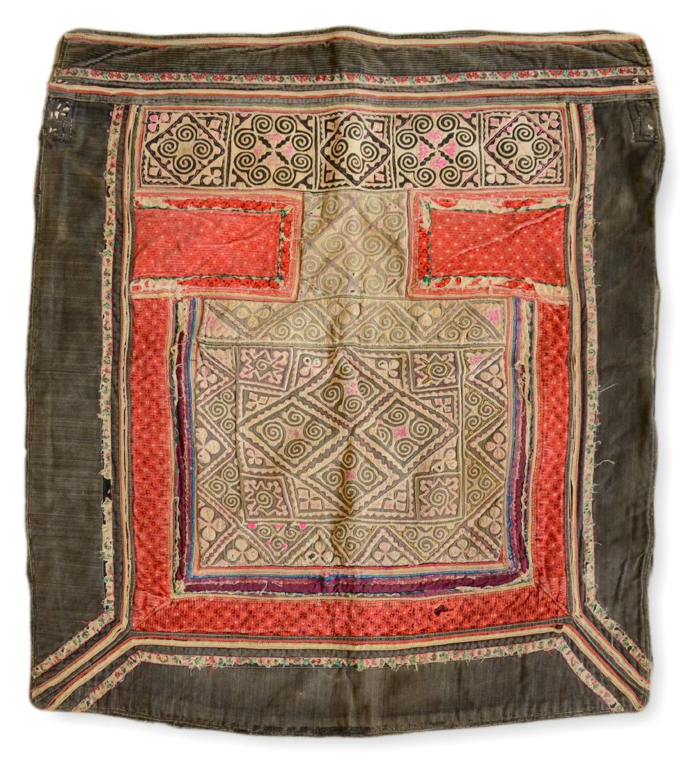 Tribal Embroidery From The Mien/Yao Tribe: A rare indigo-lined apron of red, yellow, green and black stitching on a cream ground, with two indigo squares below a wide straight band and black and red surrounds. A tribal embroidery from the Mien