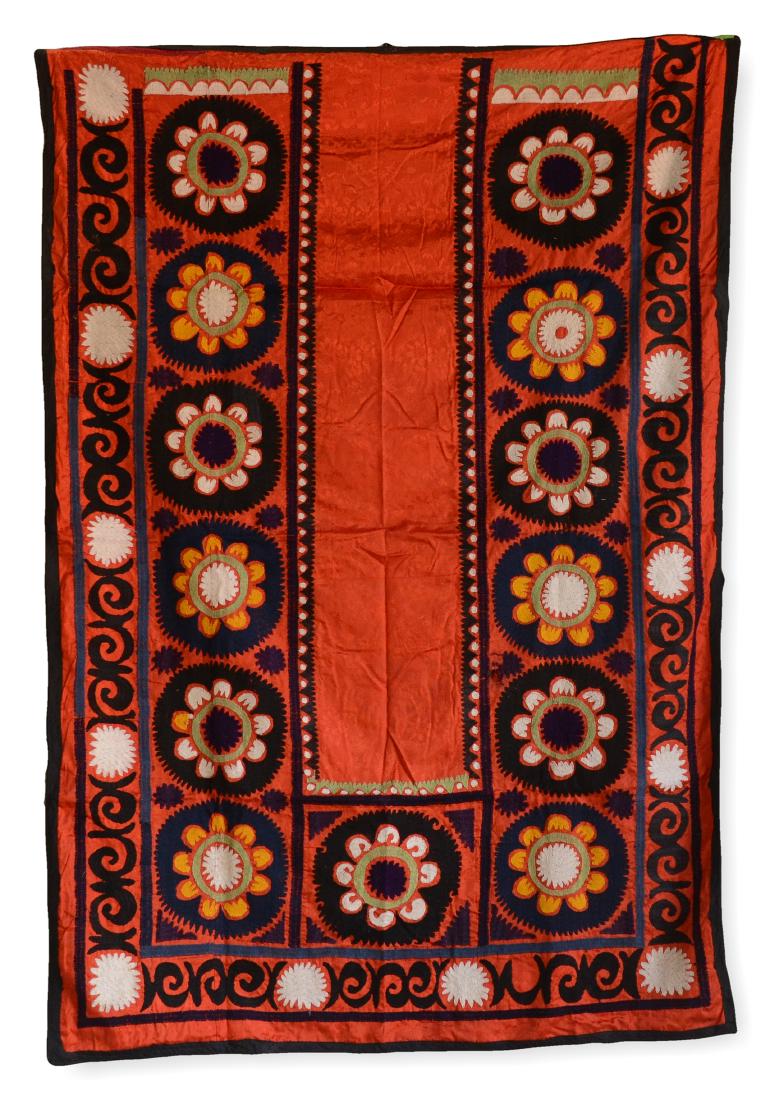 Embroidered Silk Prayer Suzani With Red Ground: A colorful, embroidered silk prayer suzani with red ground, decorated with a plain central doorway, bordered by a wide band of thirteen floral medallions, followed by a band of flower and leaf motif, 