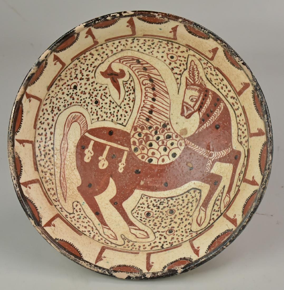 Stoneware Afghan Bowl: A brown and white under-glazed stoneware bowl, decorated with a mythological winged horse, followed by a draped band under the lip, Afghanistan. Size 10" Dia.