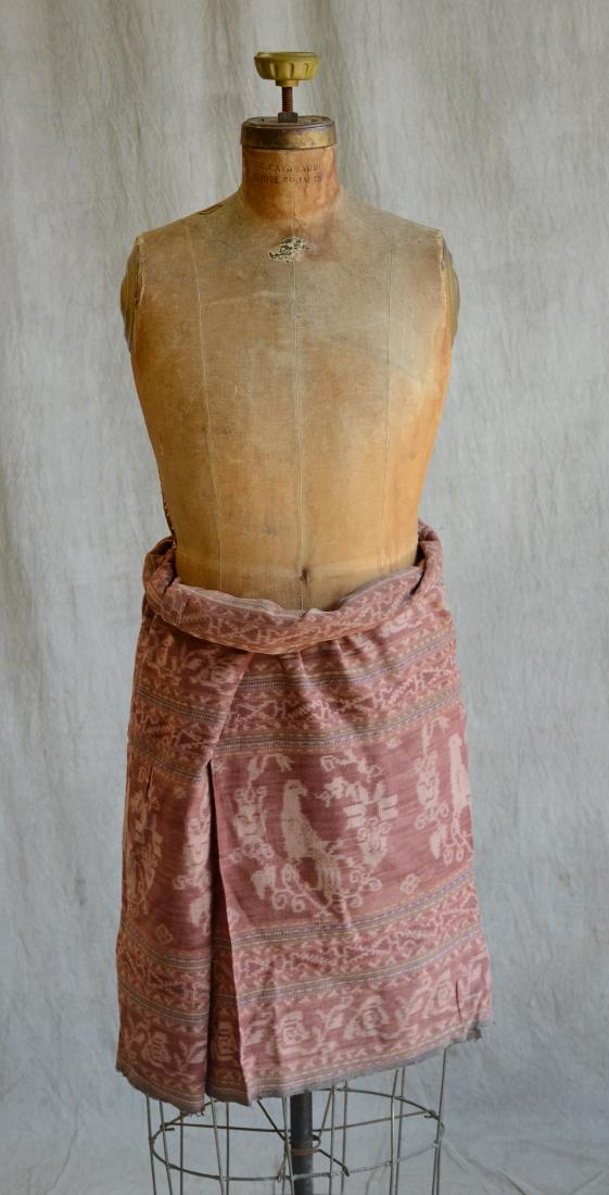 Indonesian Brown And Kombu Dyed Cotton Sarong: A finely woven brown and kombu dyed, cotton tubular sarong, decorated with columns filled with birds, surrounded by branches of flowers, interspersed with chains of flowers and geometrical motifs, tri