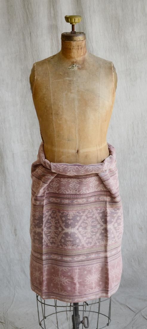 Indonesian Black And Kombu Dyed Cotton Sarong: A finely woven black and kombu dyed, cotton tubular sarong, decorated with columns filled with floral bouquets, interspersed with black stripes, geometrical motifs and vertical chain of triangles, tri