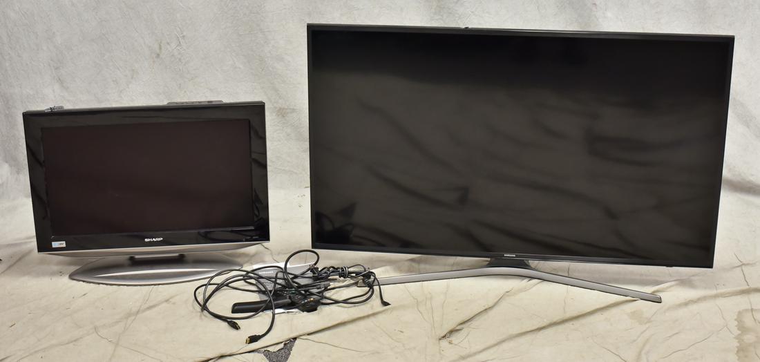 Samsung & Sharp flat screen televisions: Samsung flat screen television, 29" h x 43" w, along with Sharp flat screen television, 20" h x 26" w