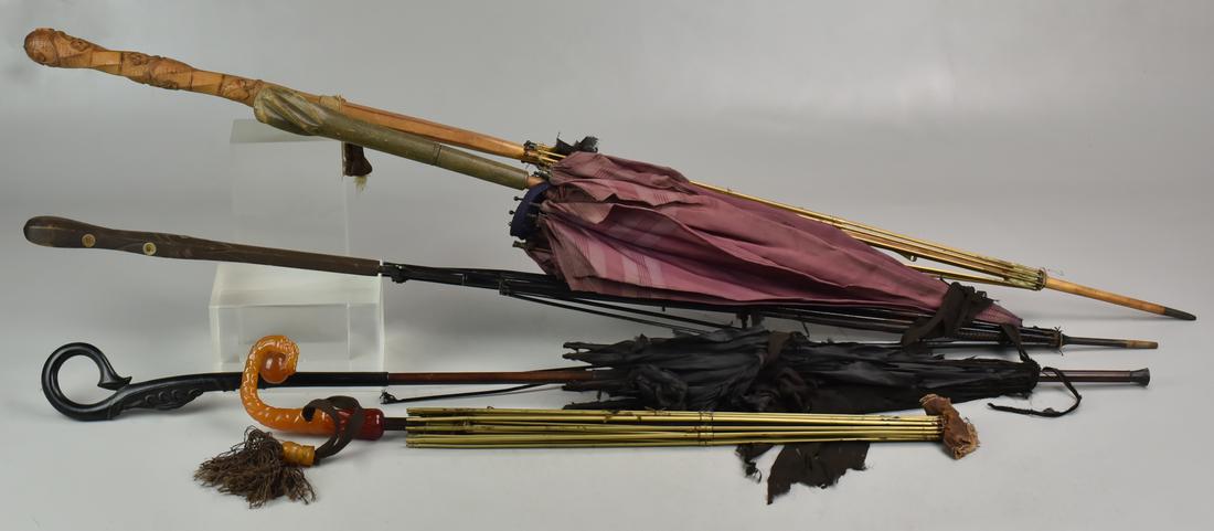 (5) Umbrellas/Parasols: (5) Umbrellas/Parasols Including Claw Holding and Ball, (2) Floral Carved Handled Umbrellas, (Some with Damage)