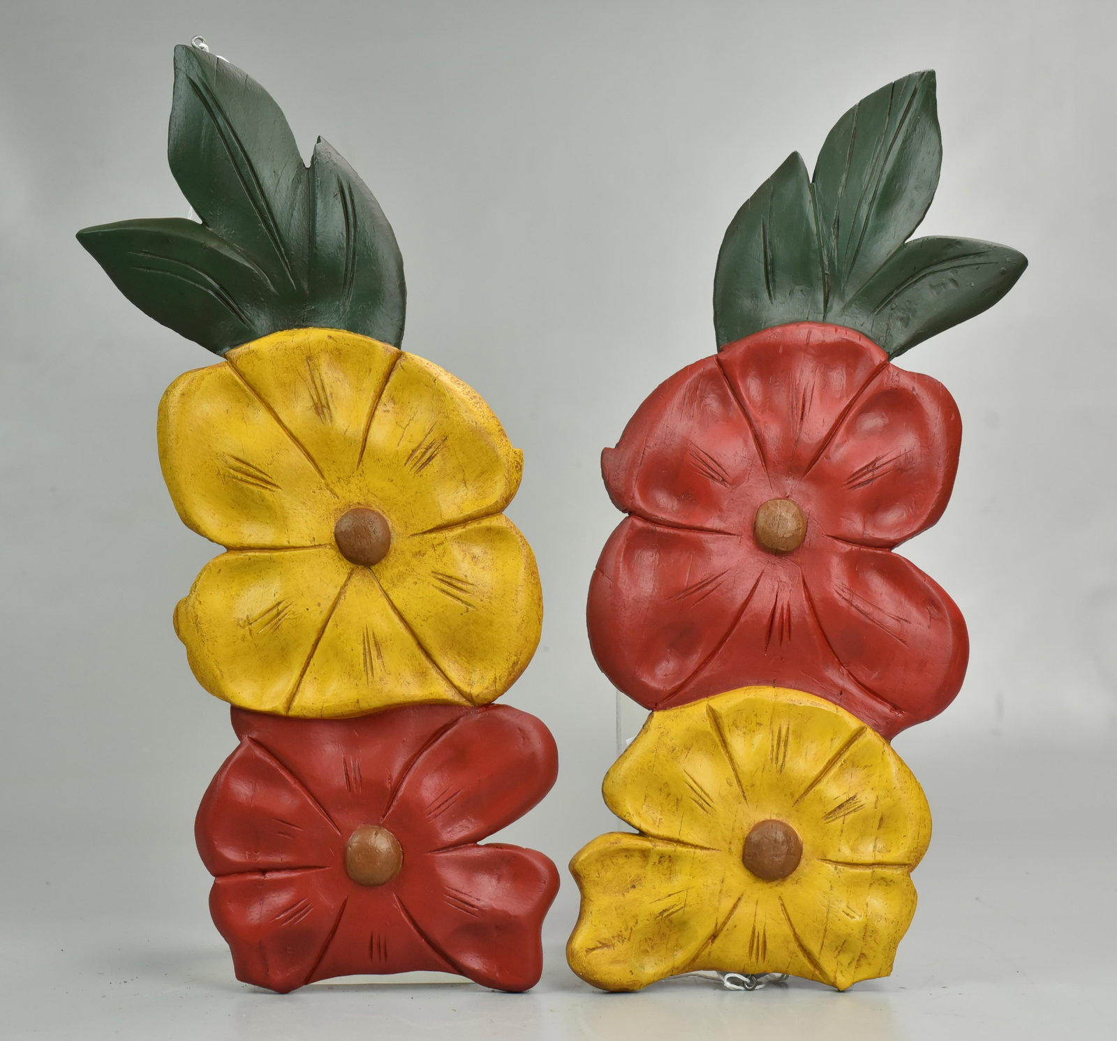 (2) decorative wood carvings from a pine carousel: (2) decorative carousel wood carvings from a pine carousel, circa 1900, flower arrangement, from Santa Claus Land Park, Putney, Vermont, Cupid with shield, on oval plaque, 21" x 16"Carved decorative w