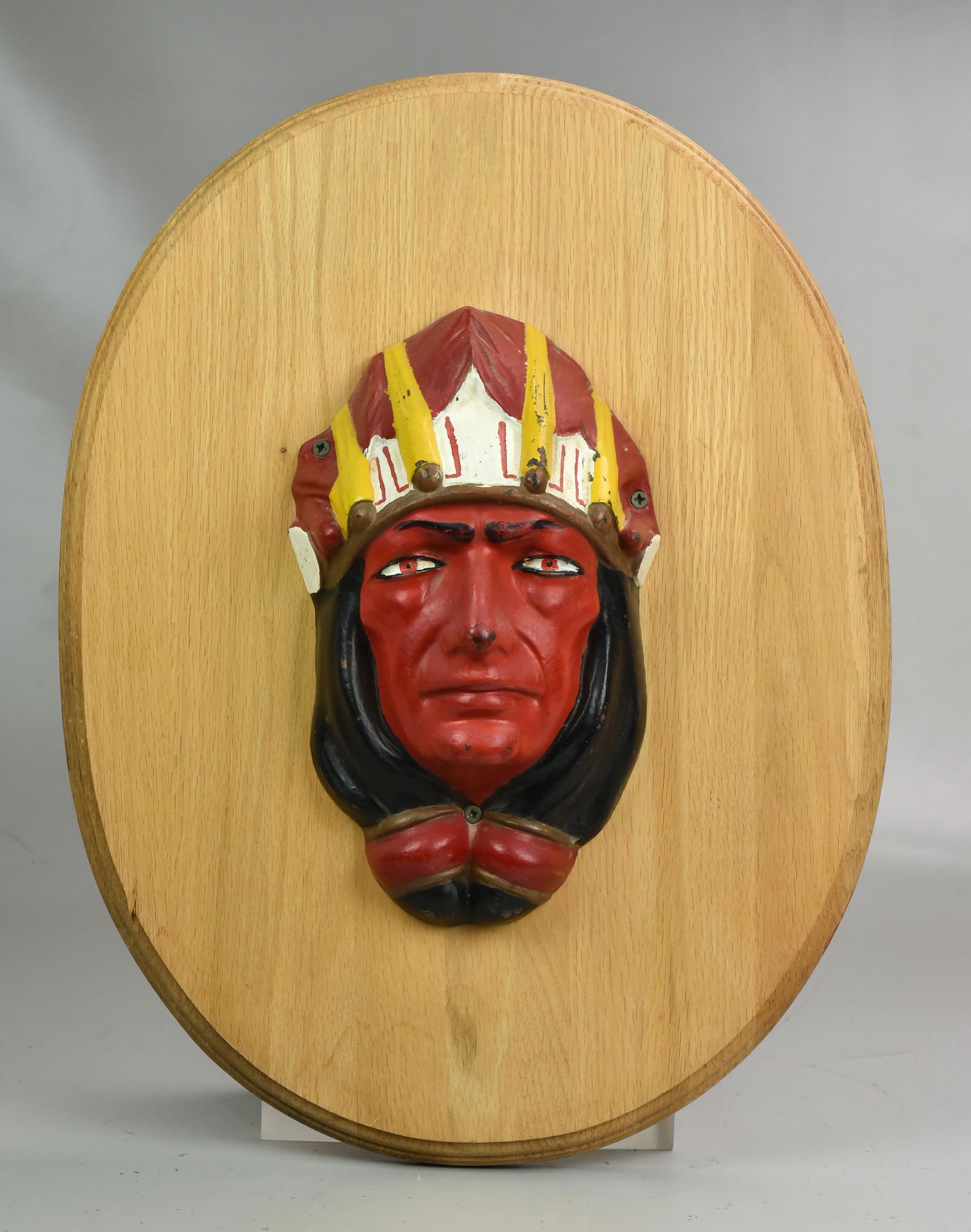 Herschel Spillman carousel cast iron Indian head: Herschel Spillman carousel cast iron Indian head, on oval plaque, circa 1900, head 11-1/2"h x 7, plaque 21" x 16"