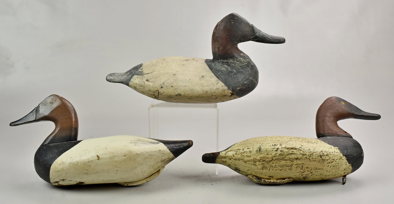 (3) unsigned carved and painted duck decoys: (3) unsigned carved and painted duck decoys, 15" l, (2) 15 1/2" long, splits, paint losses, repairs. Collection of Richard Matlat, the carver attributions are based on notes attached to the decoys by 
