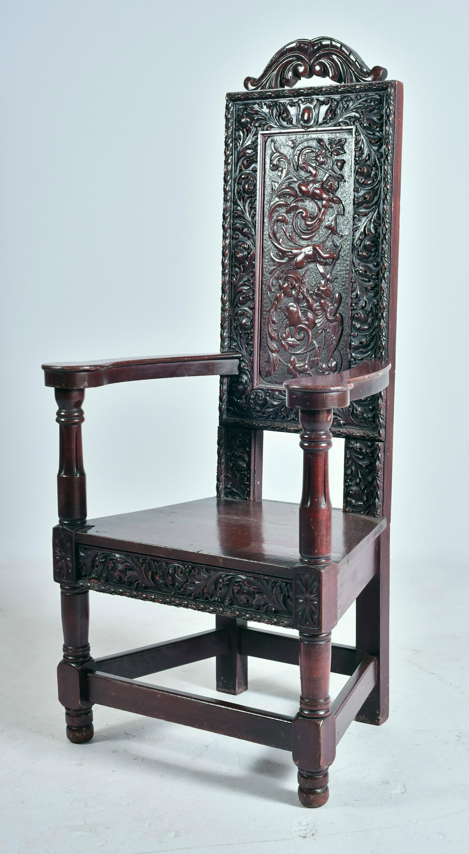Walnut carved Renaissance Revival armchair: Walnut carved Renaissance Revival armchiar with turned posts, acanthus leaf decoration surrounded by cherubs, 59" h x 28" w x 21" d