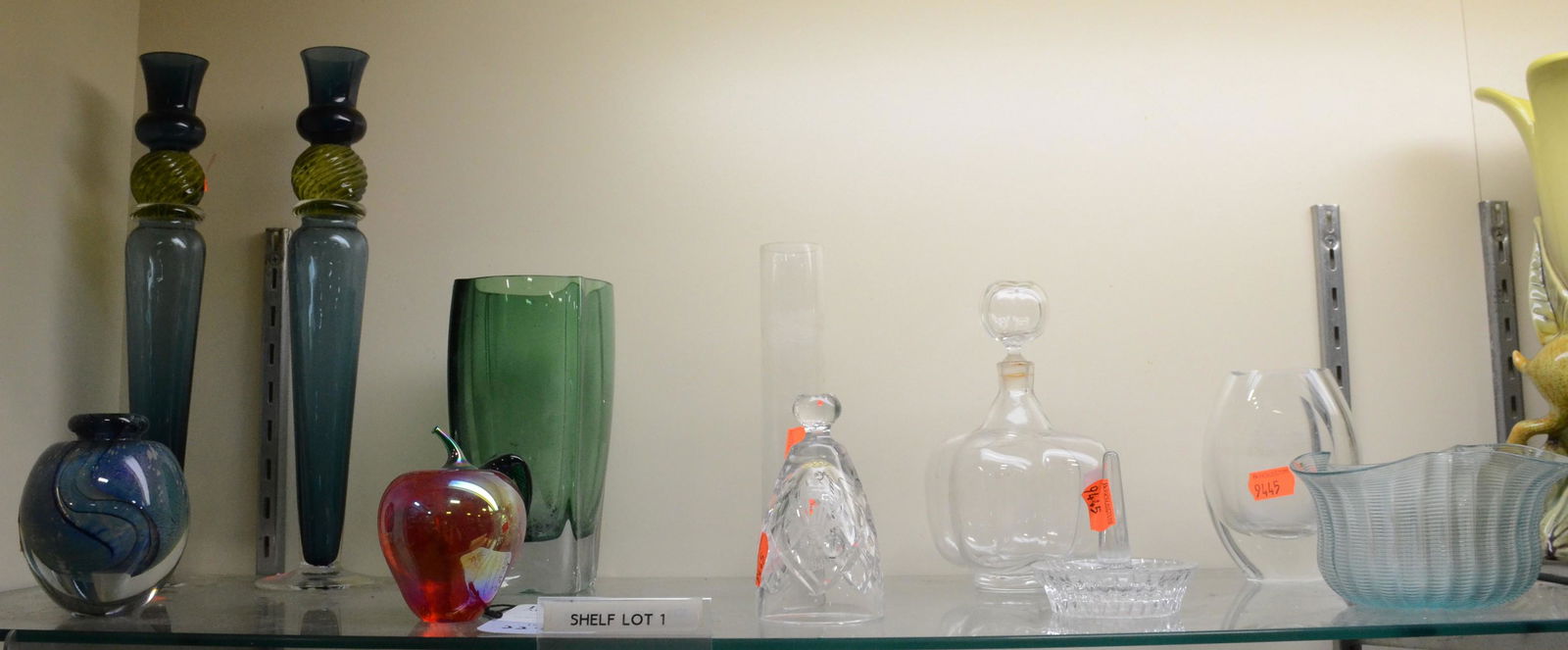 Shelf #1 - Colored and Clear Glass Lot: Shelf #1 - Colored and Clear Glass Including: Green Flygsfors Vase, Pair of Blue and Yellow Vase Signed 2001, Signatures are Illegible, Signed 1998 Eickholt Blue Vase, Glass Eye Studios (GES) Apple Pa