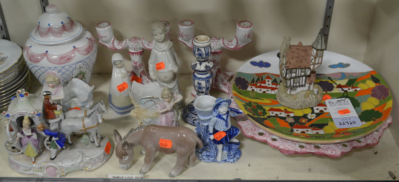 Shelf #20 - Porcelain Including Lladro: Shelf #20 - Porcelain Including: Carriage with Three People, Pink Portuguese Floral Bowl, Candlesticks and Covered Jar, Charger Depicting Village, Delft Candlestick, Rex Valencia Figure, Lladro Donkey
