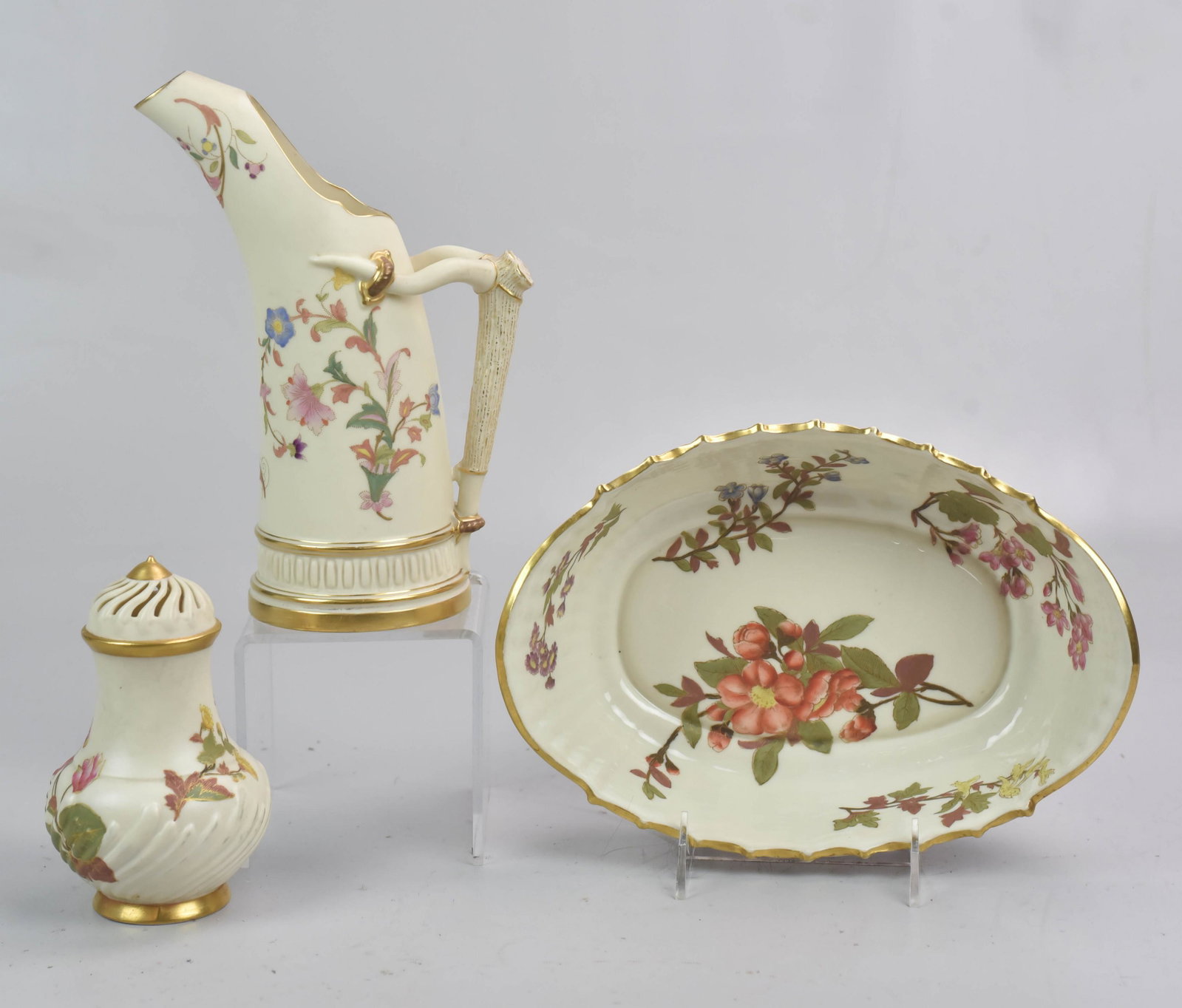 Royal Worcester Pitcher, 1887 Bowl and Muffineer: Royal Worcester staghorn handle pitcher and muffineer both with floral decoration and gold highlight. Grouping also includes Y date marked 1887 scalloped floral bowl with gold painted highlight, 10"