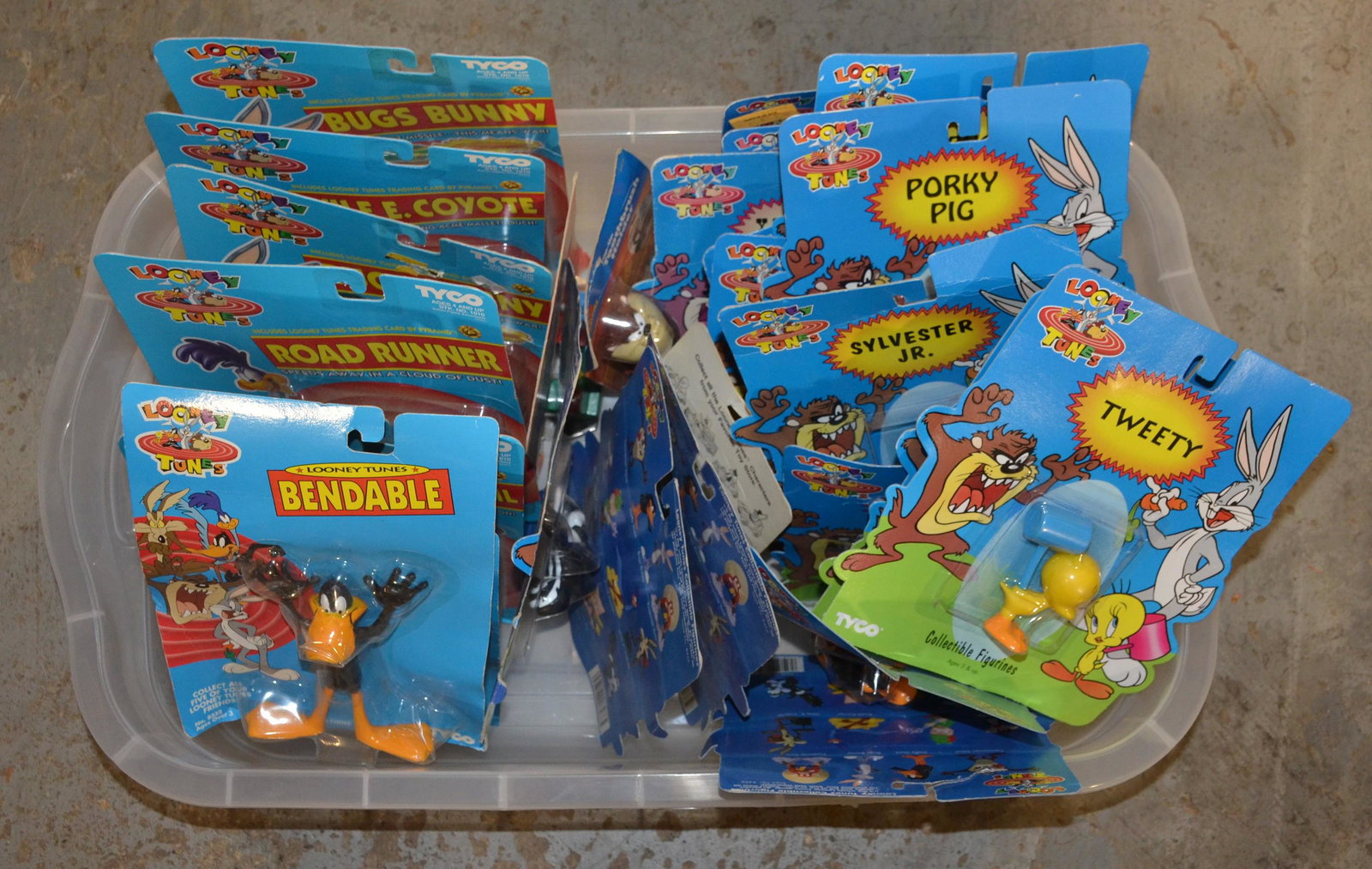 Large Lot of Looney Tunes Figures: Large lot of Warner Bros Looney Tunes figurines, including Bugs Bunny, Wile E Coyote, Daffy Duck, Road Runner, Tweety, Yosemite Sam, Sylvester, Porky Pig, all in original packaging
