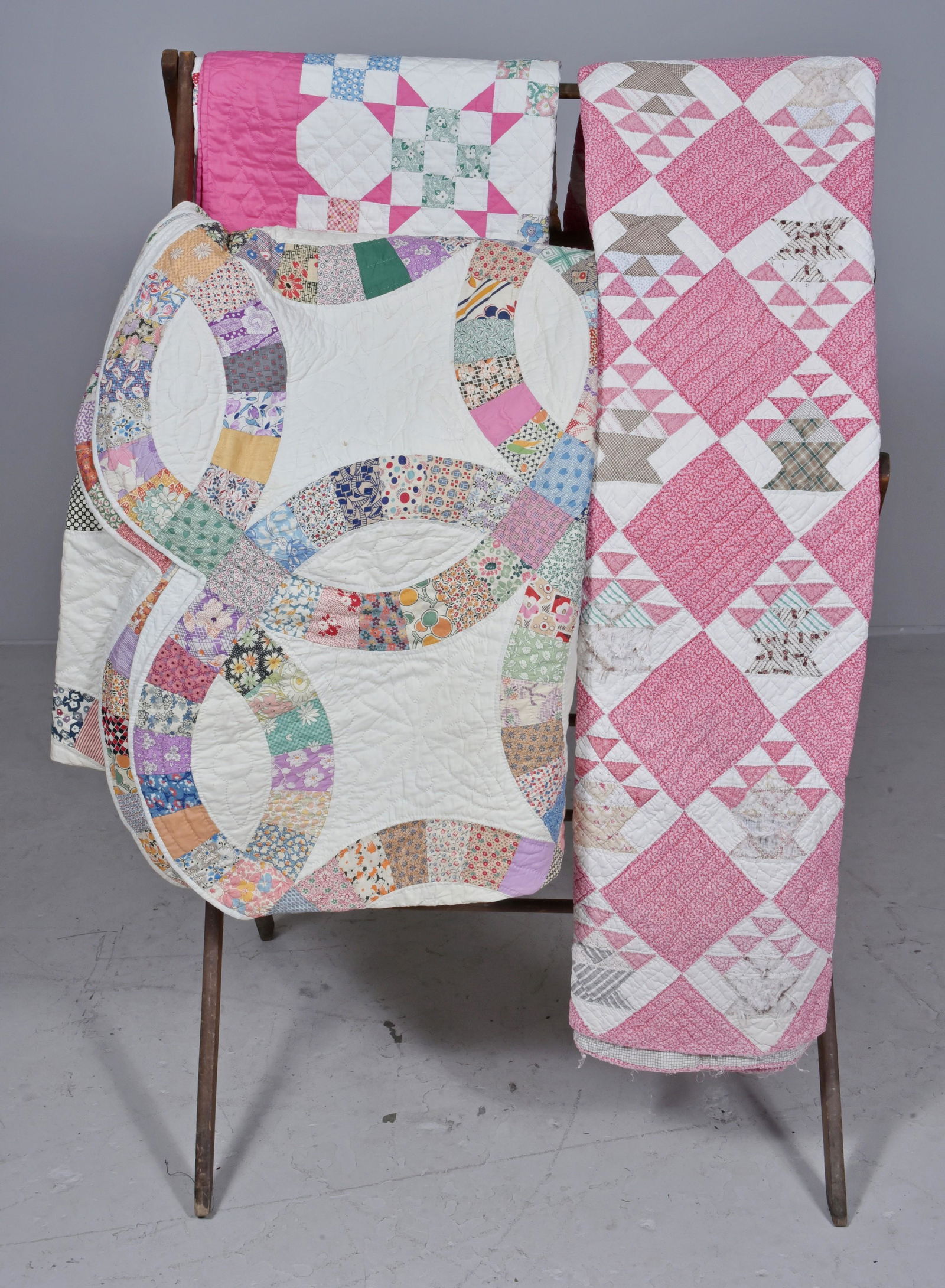 (3) Patchwork Quilts: (3) Patchwork hand stitched quilts to include 1920's wedding ring quilt, 80"x 96", 1940's tiled quilt, and antique patchwork quilt in poor condition.