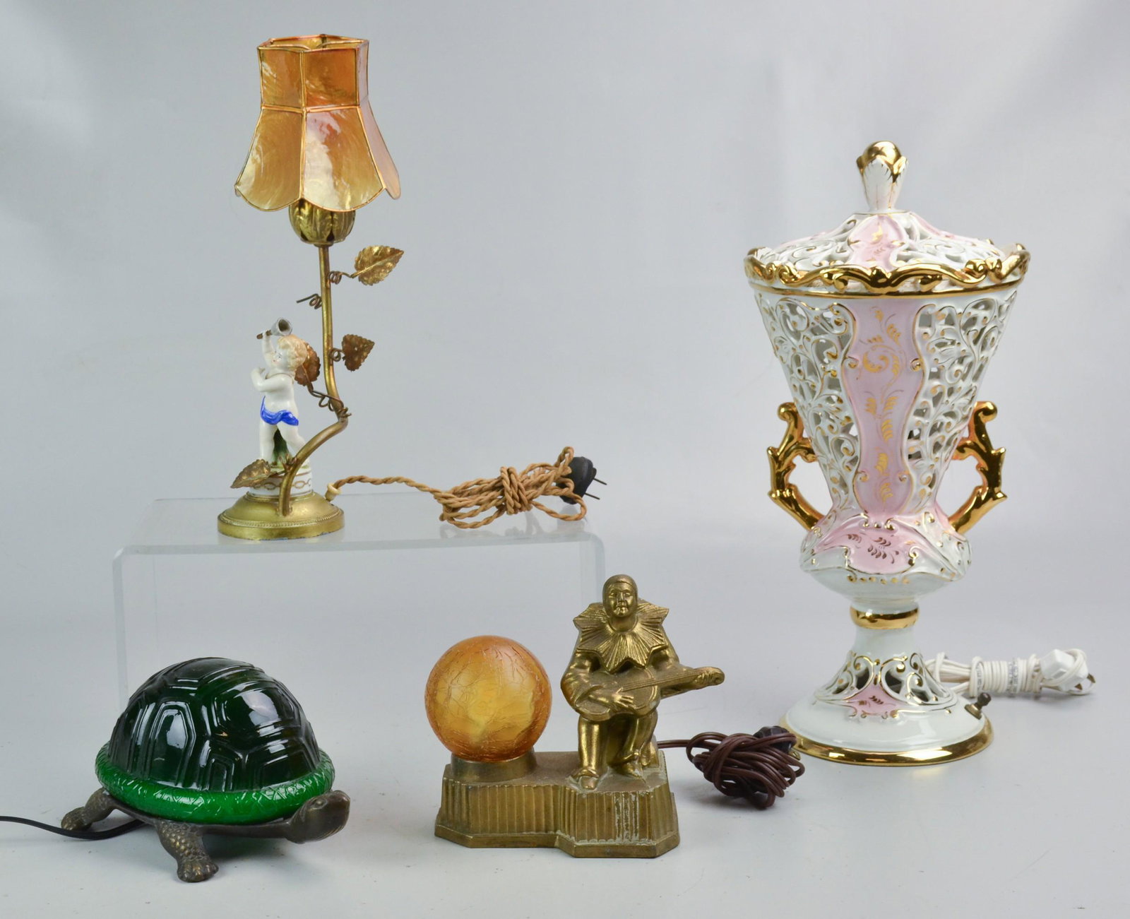 Italian and Art Deco Lamp Grouping: Lamp grouping c/o figural turtle table lamp with green shade shell, Art Deco table lamp with pierrot playing guitar, Italian porcelain lamp with broken putti and pierced Italian porcelain urn form tab