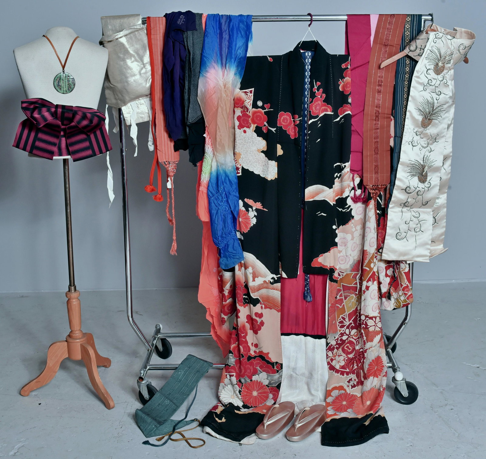 Japanese Cherry Blossom Kimono: 1950's all silk Japanese cherry blossom adorned kimono lined in red silk with pink jacquard trim. Grouping also includes beaded wedding sash, gold formal sandals with matching sash, and assorted sashe