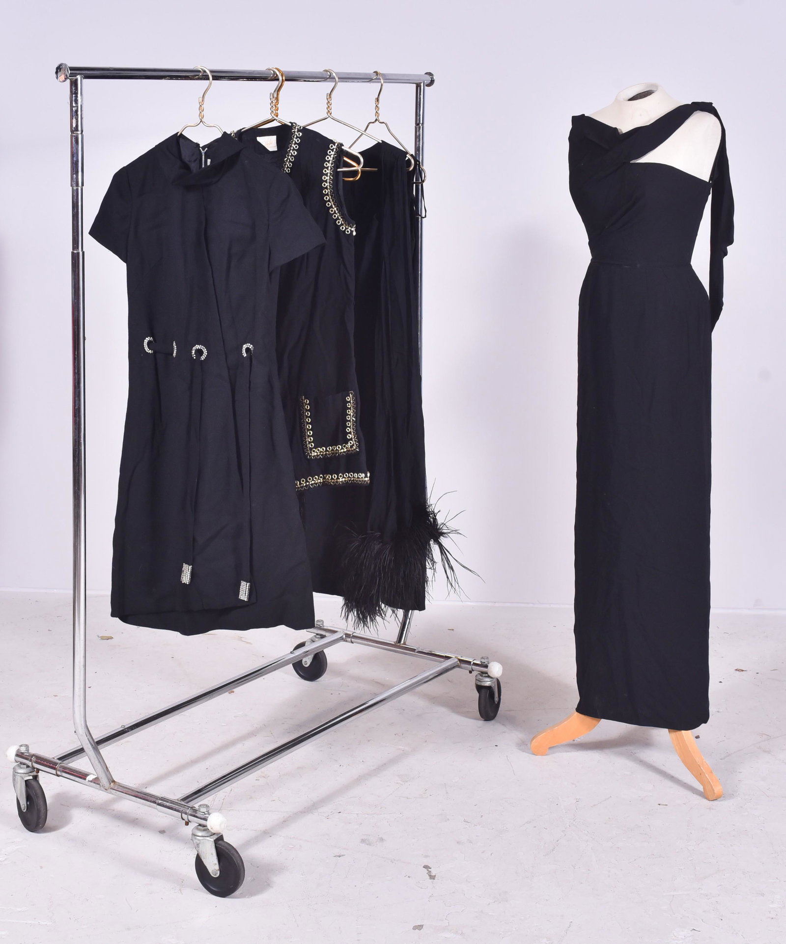 (5) 1960s Cocktail Outfits: (5) 1960's cocktail outfits to include (1) stunning full length Dorothy O'Hara pillar dress with Asymmetrical neckline and shoulder tie, 30" bust, 24" waist 36" hips, (1) 1960's black wool Arbe dress 