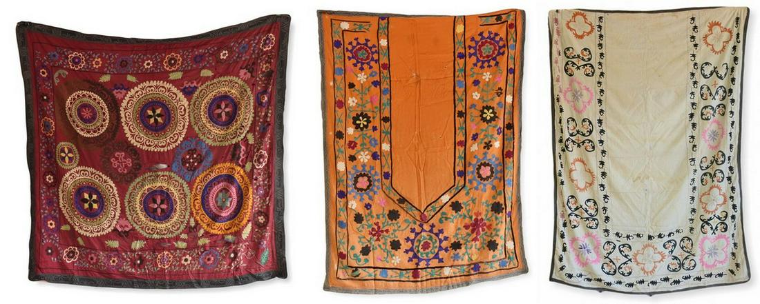 (3) Embroidered Suzanis: (3) Embroidered Suzanis to include: (A) blue silk embroidered prayer rug, decorated with a wide panel of floral-vine clusters surrounding the central door and followed by a chain border, Bokhara, Uzbe