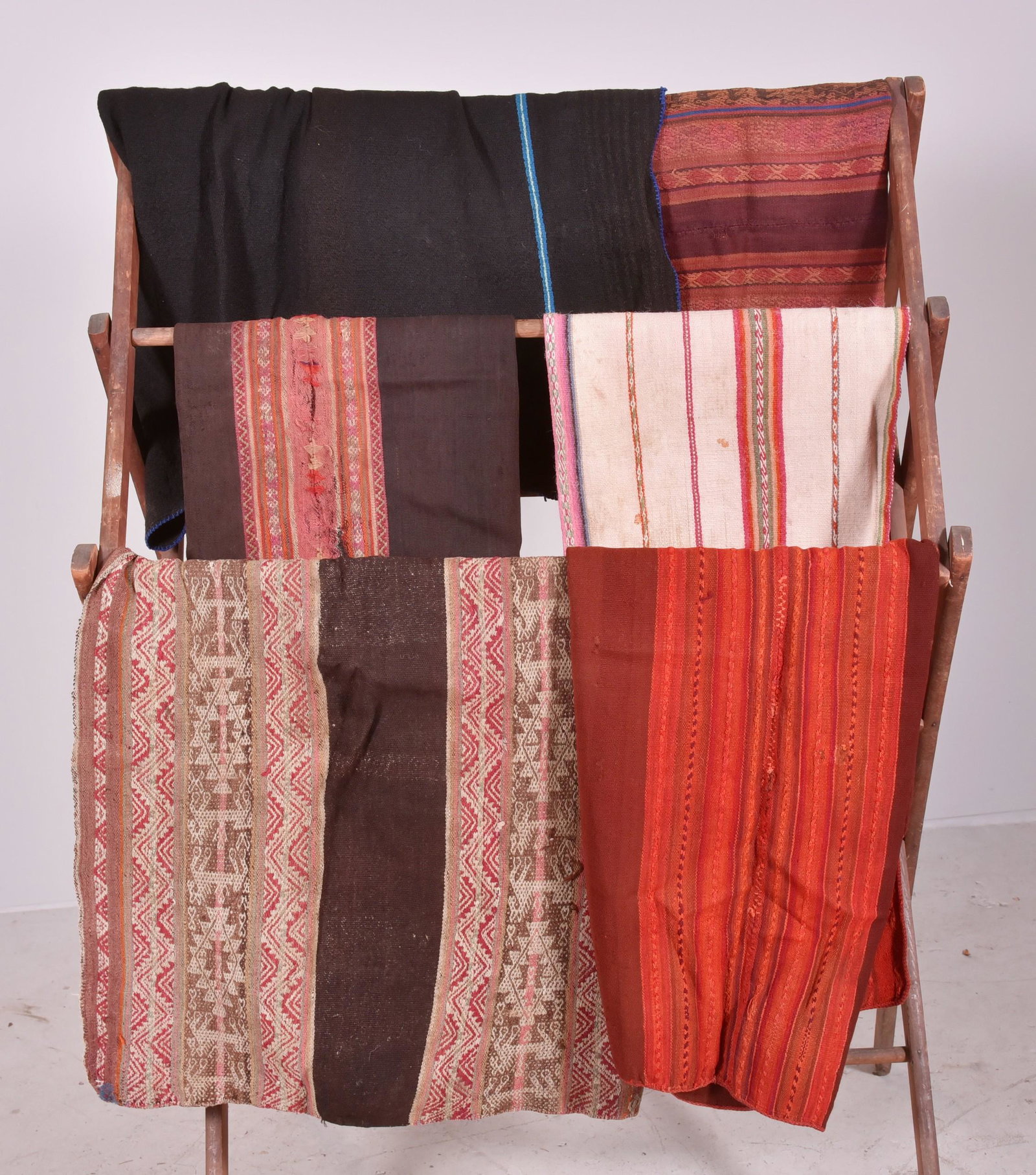 (6) Embroidered Suzanis: (6) Embroidered Suzanis: (A) Treadle loomed, plain weft faced and dovetailed tapestry weave in two sections with hand sewing black field framed by two narrow blue stripes, Guatemala. Size 62" x 60" (B