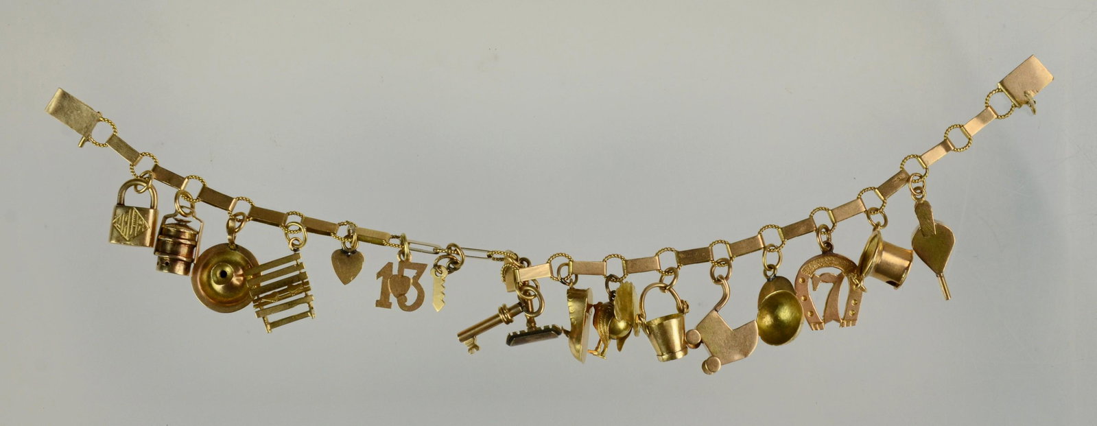 14K Gold Charm Bracelet: 14K Gold Charm Bracelet with Bench, Lock, Stroller, Key, Horseshoe (10.8 Dwt)