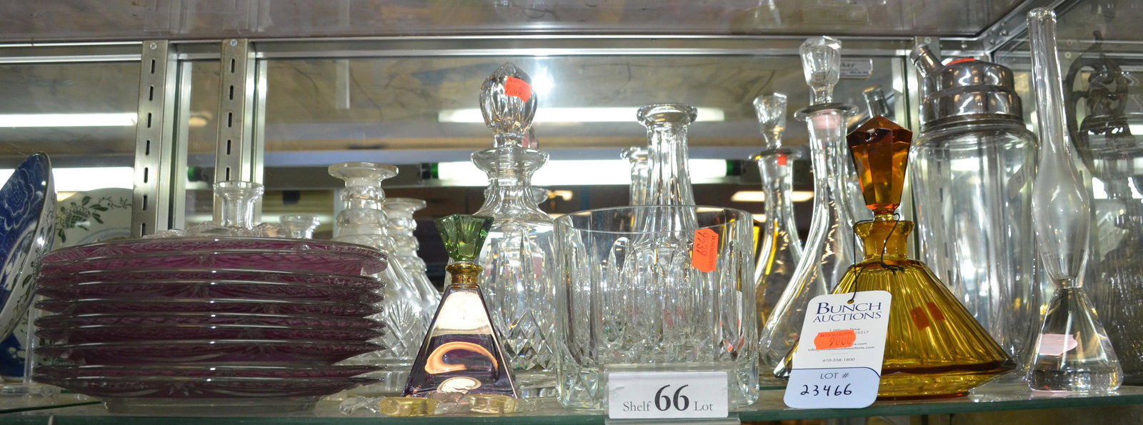 Shelf #66 -Crystal and Glass Lot: Shelf #66 - (3) Cut Crystal Decanters, Crystal Ice Bucket, Glass Decanter, Glass Cocktail Shaker, Royal Limited Perfume Bottle, Amber Faceted Perfume Bottle (Chips to Stopper), Orrefors Bud Vase, (10)