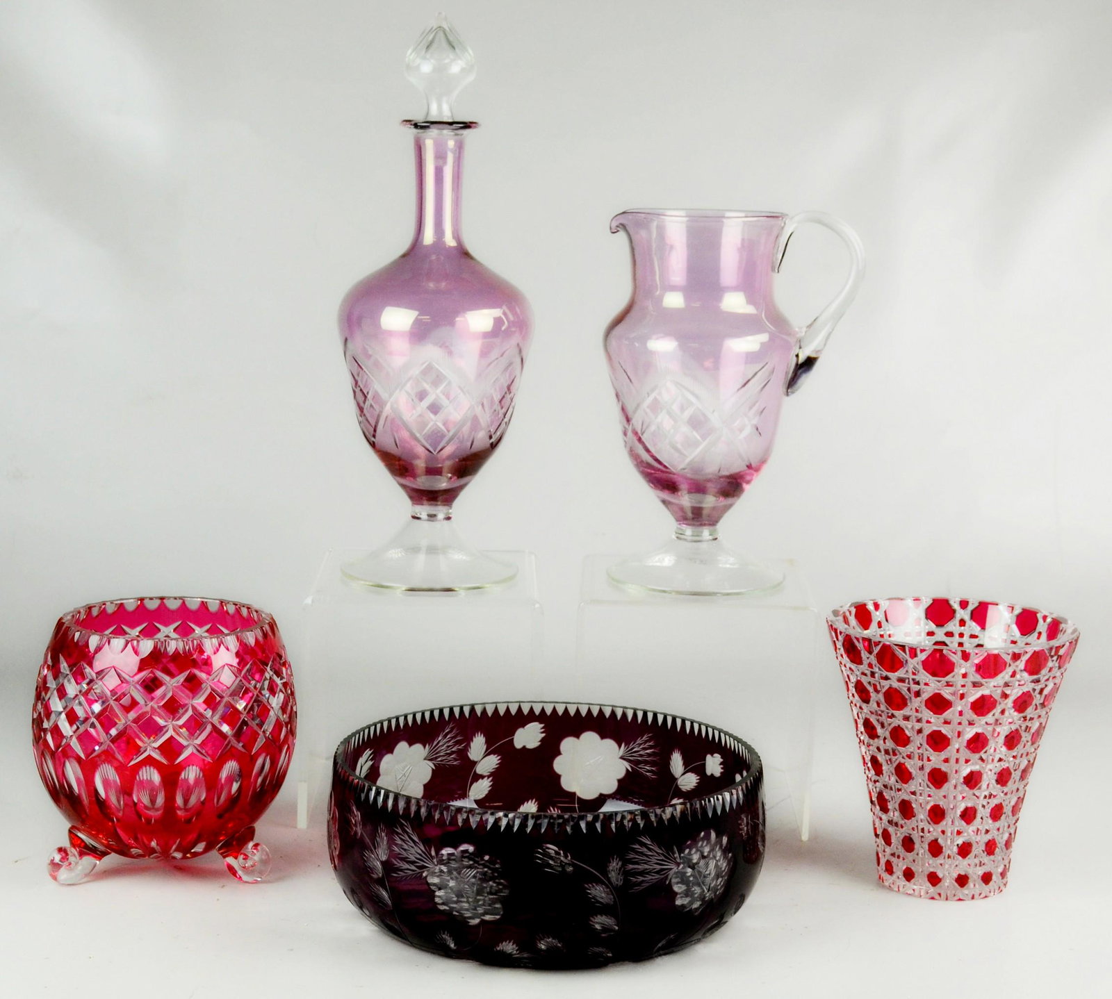 (5) Piece Cut Glass Grouping: (5) Piece cut glass grouping c/o Bohemian lavender cut to clear pitcher and decanter, 15" h, Bohemian amethyst cut to clear 9.5" bowl with small chip at rim and (2) ruby cut to clear vase and footed b